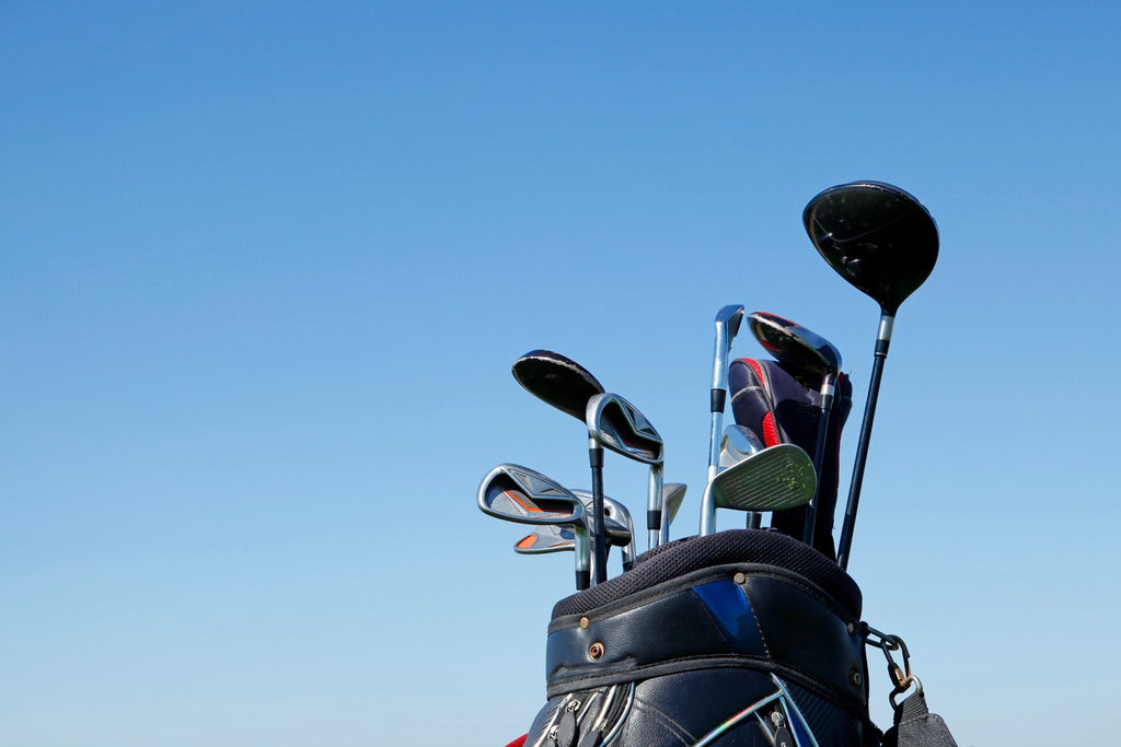 Bag of golf clubs against blue sky