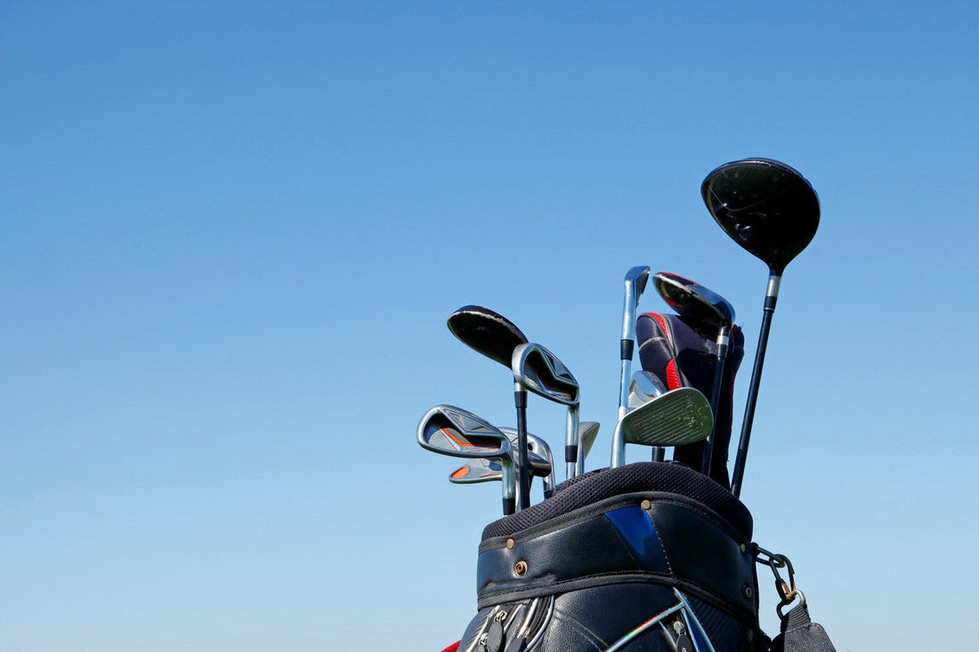 Bag of golf clubs against blue sky