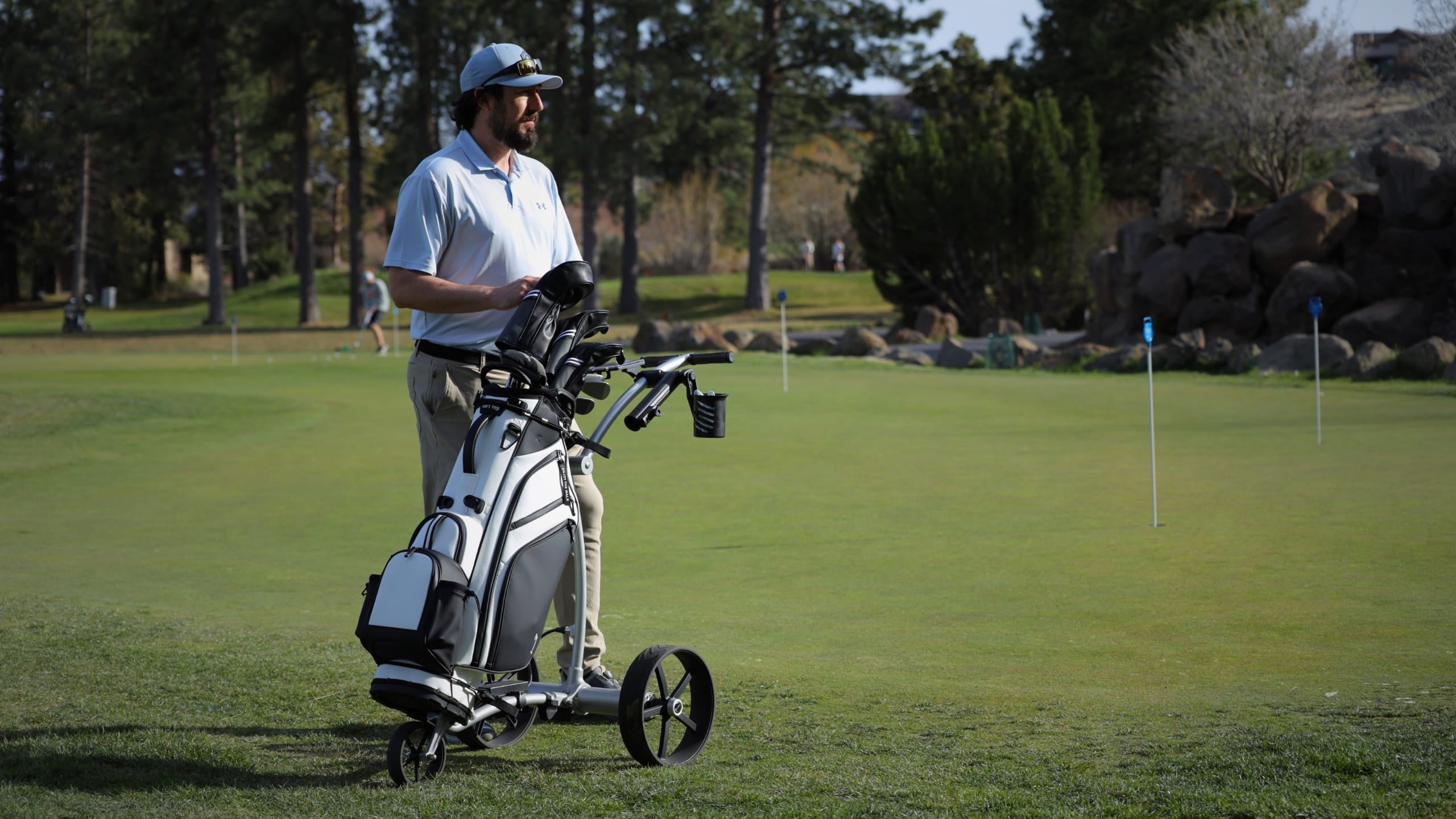 Durable golf cart bag with 14-way divider on electric push cart—high-quality storage solution for walking golfers on any terrain.