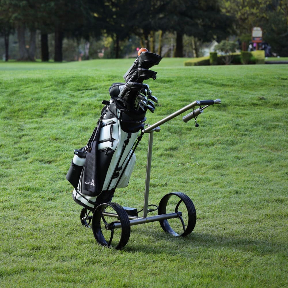 Side view of the Galaxy Titan electric golf trolley in use on a fairway, highlighting its sleek frame, stable tires, and powerful electric push cart build.