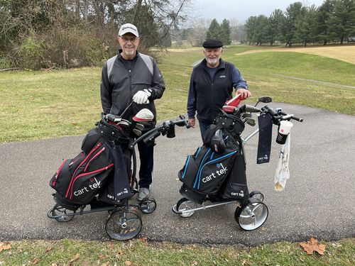 customers with electric golf carts on cart path
