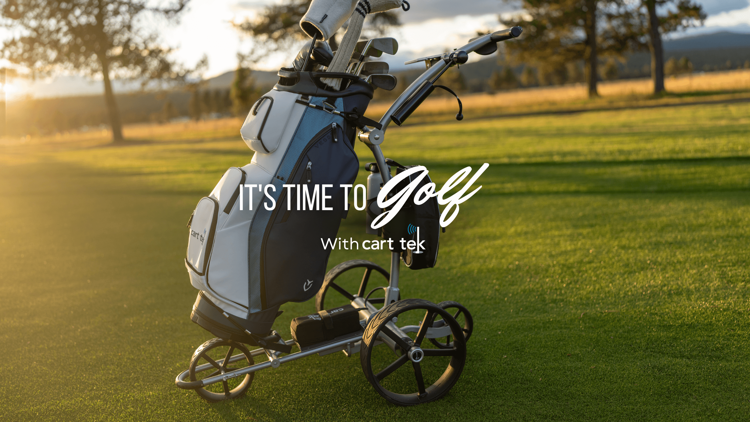 cart tek electric golf carts on a fairway at sunset