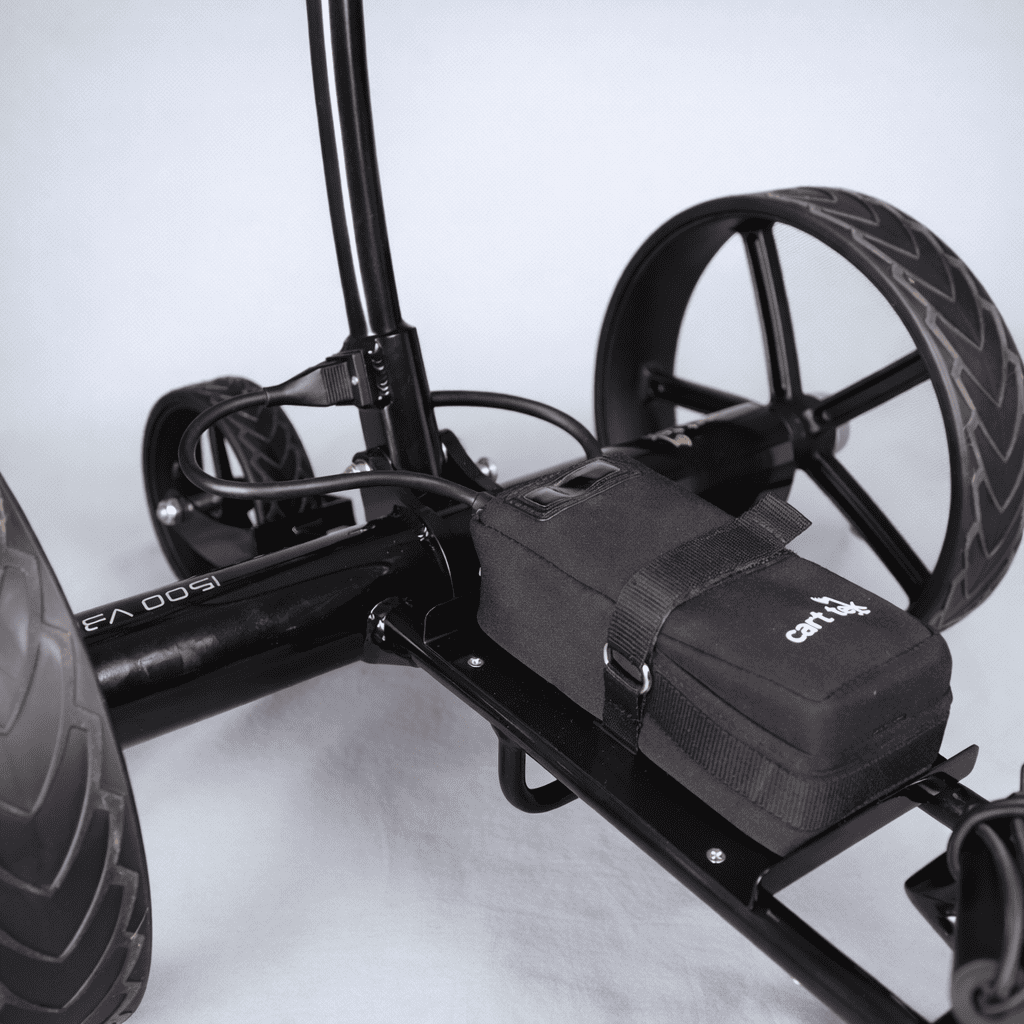Close-up of the battery compartment/bag mounted on the black Cart Tek 1500 V3 electric golf caddy frame between the rear wheels.