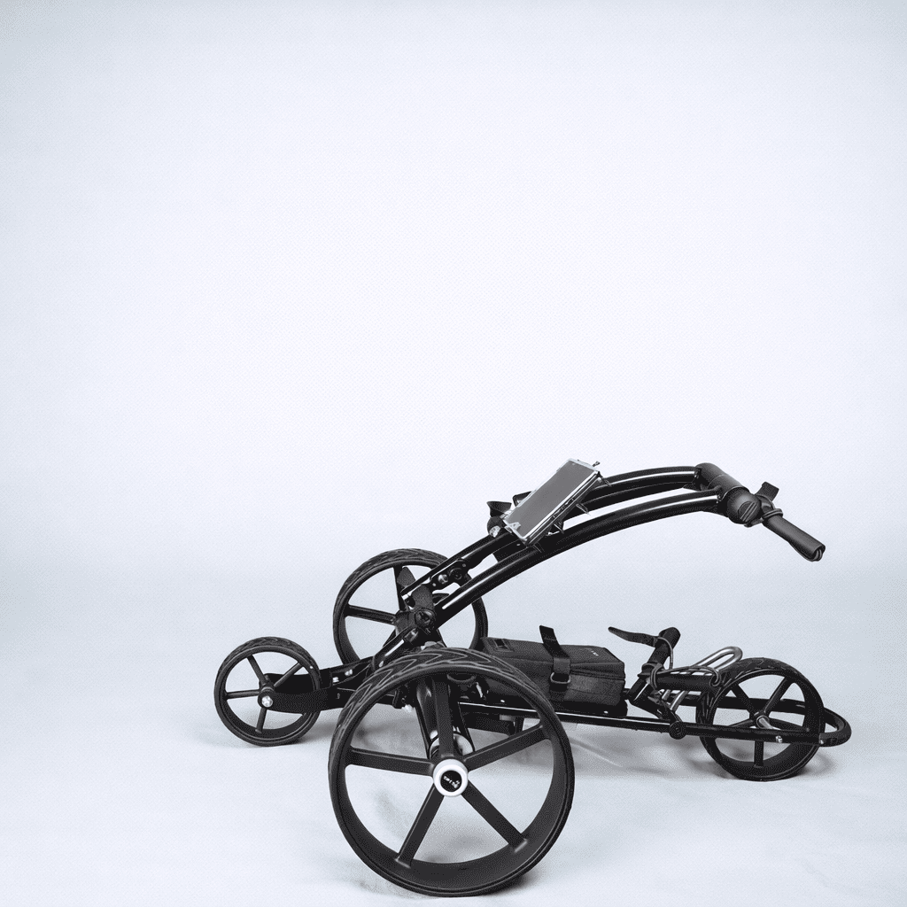 Black Cart Tek 1500 V3 electric golf caddy folding down for transport, side view on a light gray studio background.