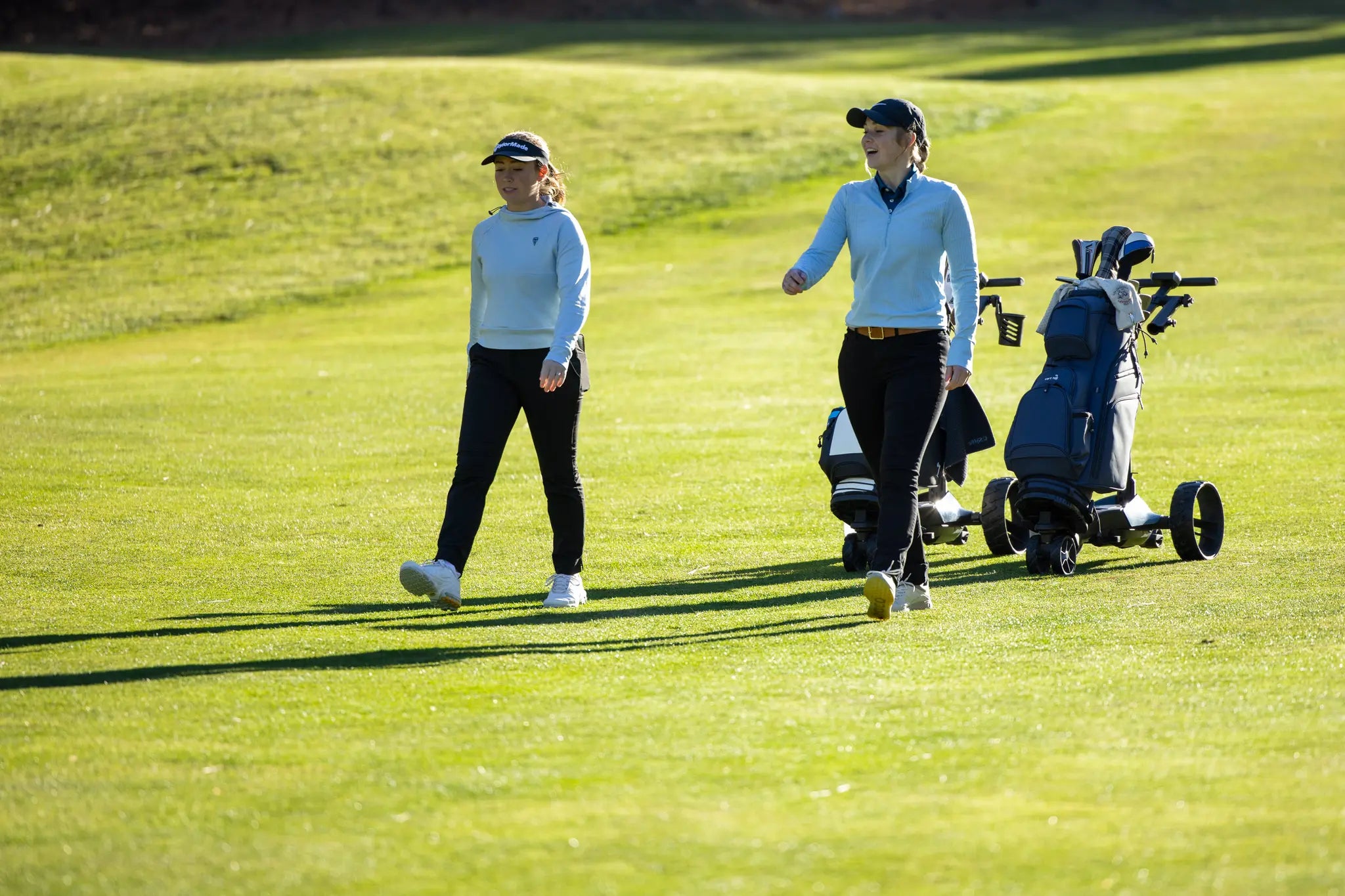 Golfers walking the course hands-free with FORMULA Pursuit electric golf caddy