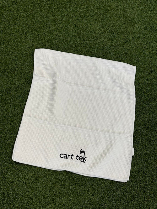 white-microfiber-towel laid on green grass