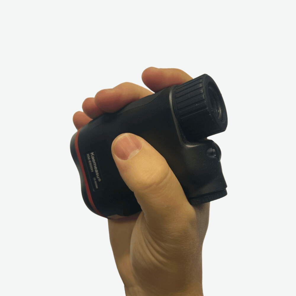 Kaemeasu golf range finder in right hand on white background.